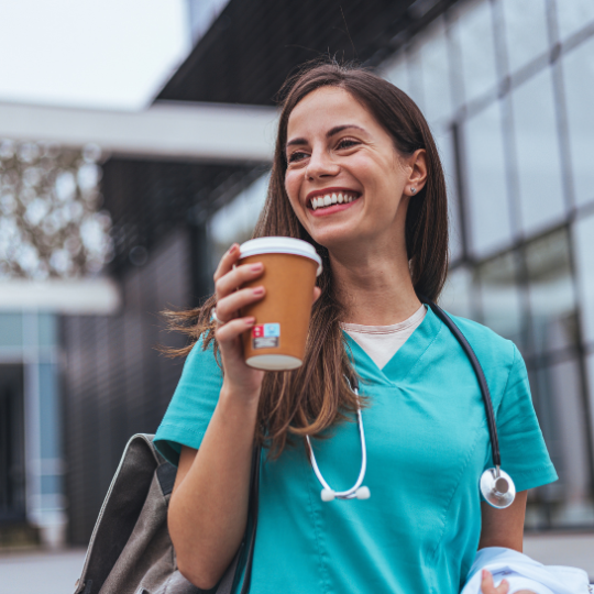TotalMed nurse on way to work, holding to-go coffee cup.